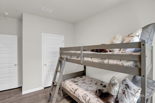 bedroom with hardwood / wood-style floors