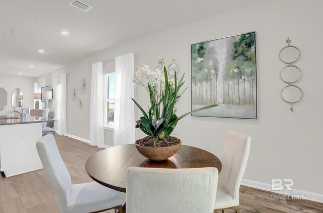 dining space with hardwood / wood-style floors