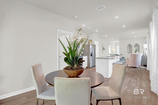 dining room featuring hardwood / wood-style floors and sink