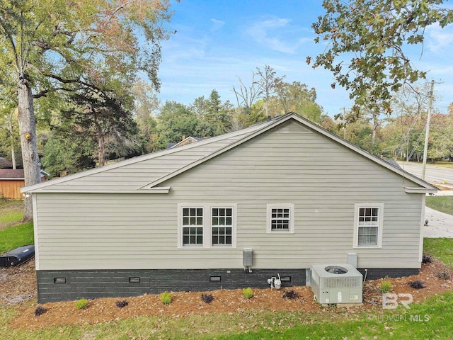 view of side of home with central air condition unit