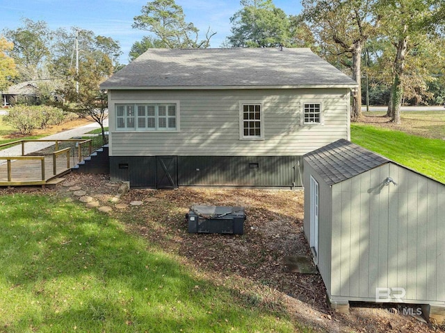 view of home's exterior with a wooden deck and a yard