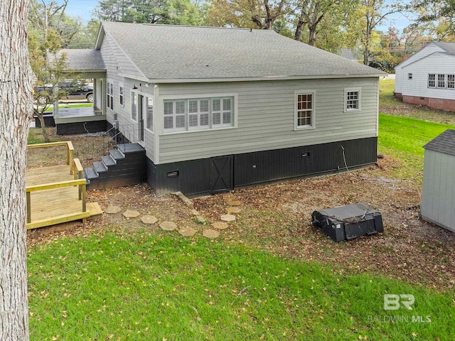 rear view of house featuring a lawn