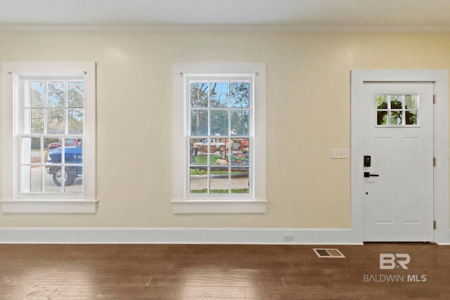 foyer entrance with hardwood / wood-style floors and ornamental molding