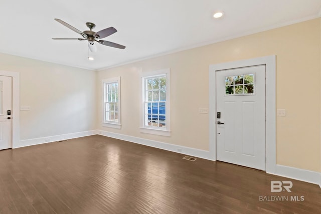 entrance foyer with crown molding, ceiling fan, and dark wood-type flooring