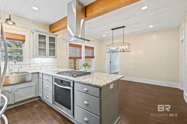 kitchen featuring gray cabinets, dark hardwood / wood-style flooring, island exhaust hood, and appliances with stainless steel finishes