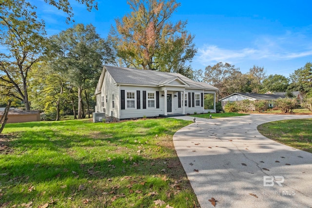 view of front of property with a front lawn and cooling unit