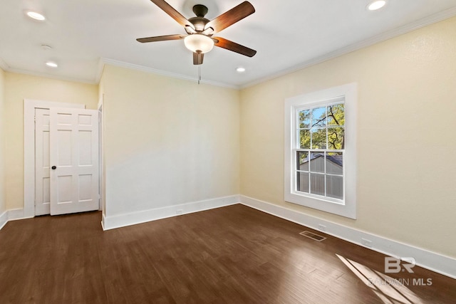 empty room with crown molding, ceiling fan, and dark hardwood / wood-style floors