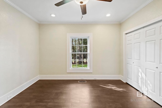 unfurnished bedroom featuring a closet, ceiling fan, dark hardwood / wood-style flooring, and crown molding