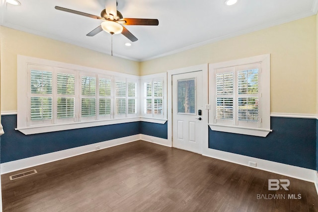 interior space with dark hardwood / wood-style floors, ceiling fan, and ornamental molding