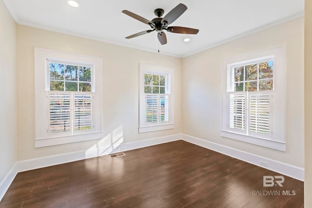 empty room featuring wood-type flooring, plenty of natural light, ornamental molding, and ceiling fan