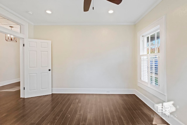 empty room with a healthy amount of sunlight, crown molding, and dark wood-type flooring