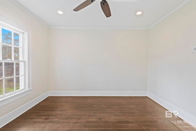 spare room featuring ceiling fan, dark wood-type flooring, and ornamental molding