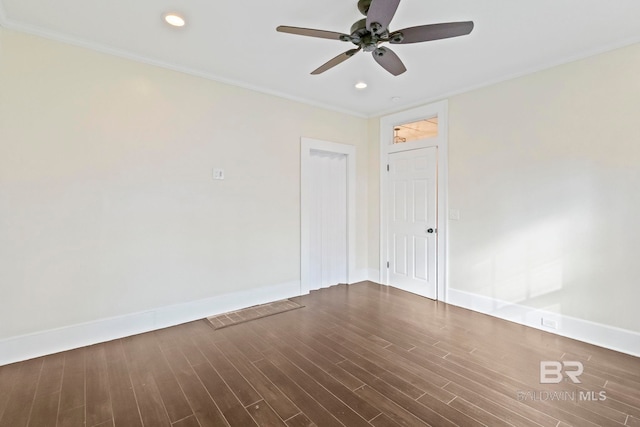 unfurnished room featuring ceiling fan, dark hardwood / wood-style flooring, and crown molding