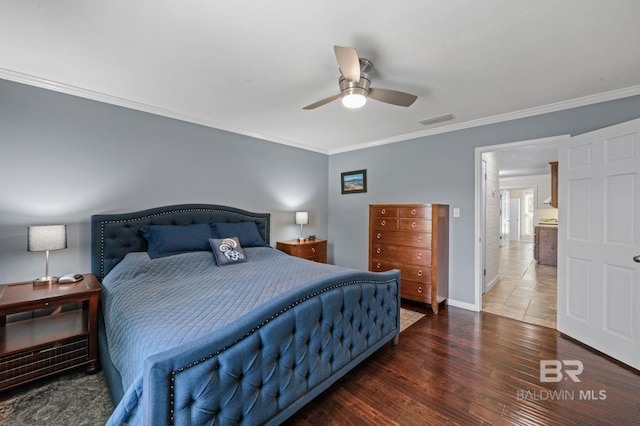 bedroom featuring ornamental molding, ceiling fan, and dark wood-type flooring