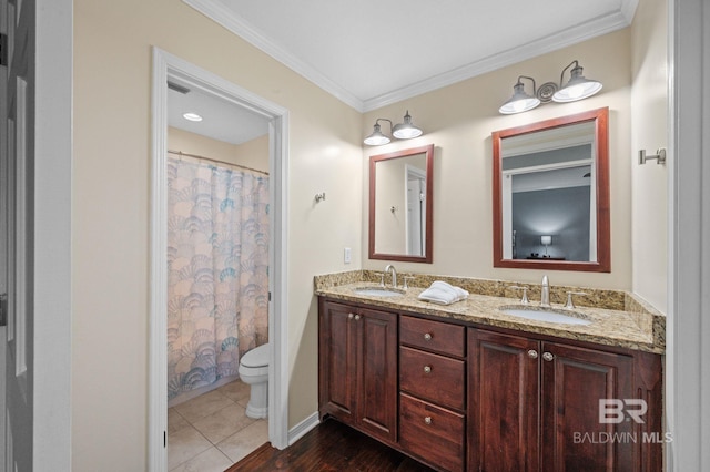 bathroom with tile patterned flooring, toilet, vanity, and ornamental molding