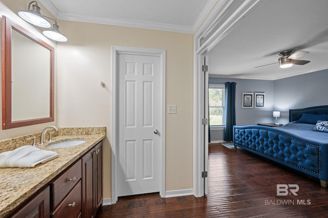 bathroom featuring hardwood / wood-style floors, ceiling fan, crown molding, and vanity