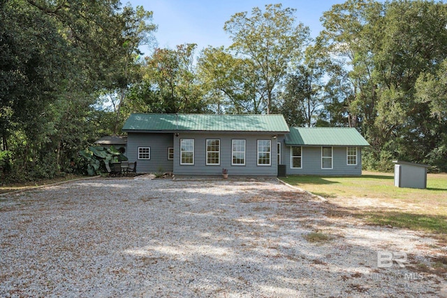 ranch-style house with a storage unit