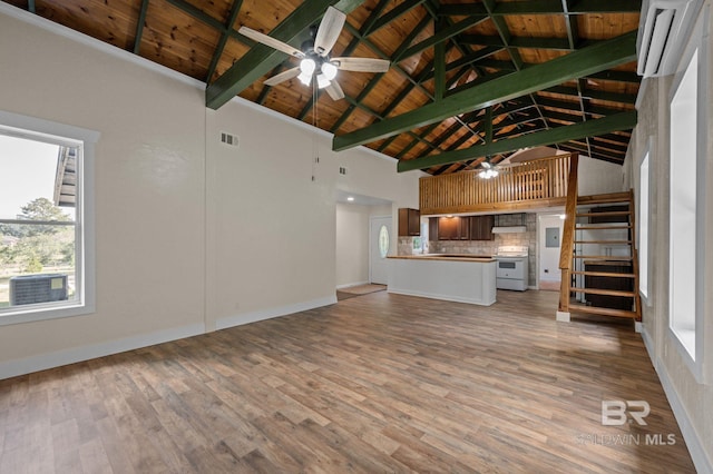 unfurnished living room with beamed ceiling, hardwood / wood-style floors, high vaulted ceiling, and wood ceiling