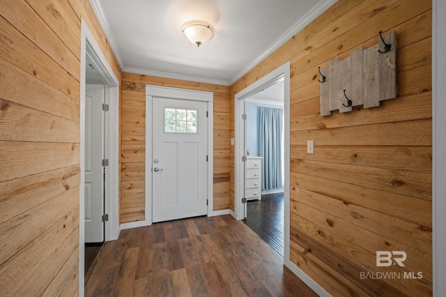 doorway to outside featuring wood walls, crown molding, and dark wood-type flooring