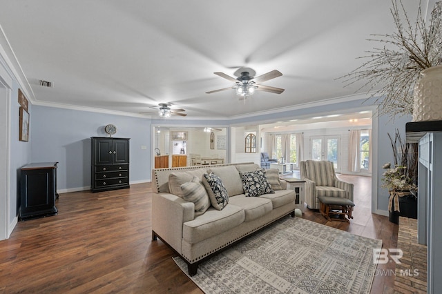 living room featuring dark hardwood / wood-style flooring, ceiling fan, and ornamental molding