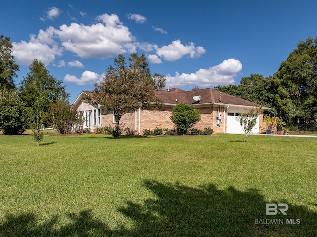 view of front of house with a front yard and a garage