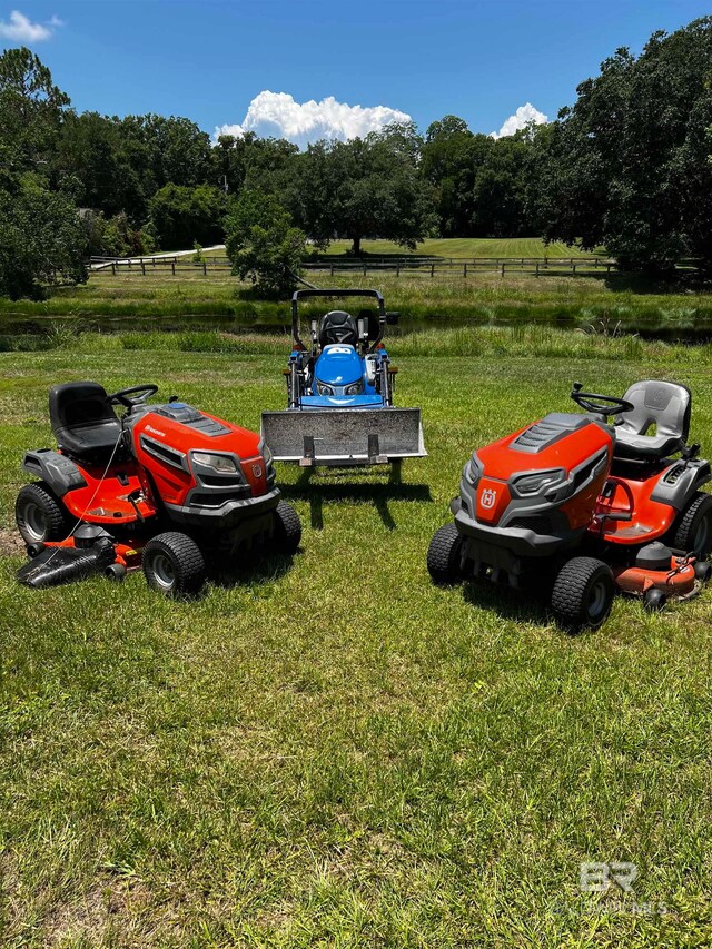 view of parking / parking lot with a yard and a rural view