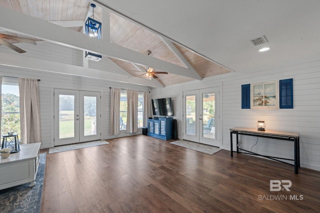 unfurnished living room featuring wood walls, wooden ceiling, french doors, beamed ceiling, and dark hardwood / wood-style flooring