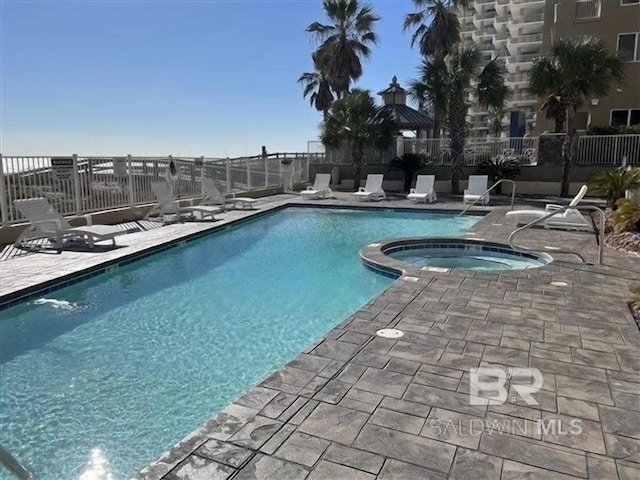 view of pool featuring a patio area and a hot tub