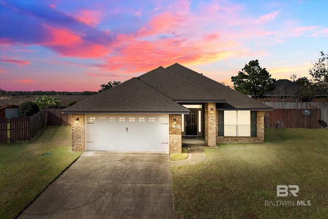 view of front of house featuring a lawn and a garage