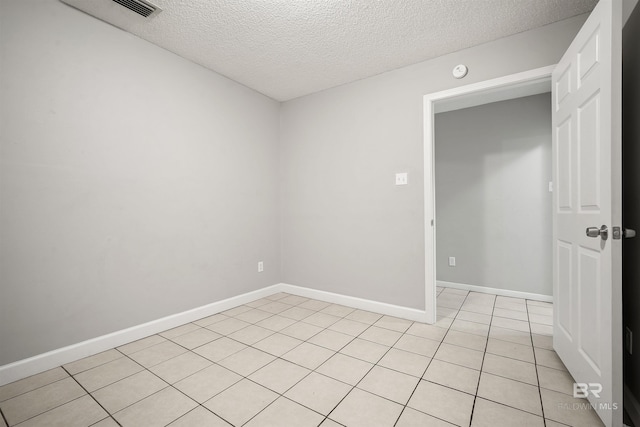963 Shady Brook Dr, Mobile, AL 36606 - empty room with a textured ceiling, light tile patterned floors, baseboards, and a smoke detector