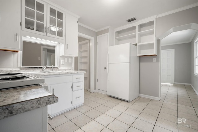 963 Shady Brook Dr, Mobile, AL 36606 - kitchen with freestanding refrigerator, light tile patterned flooring, arched walkways, open shelves, and ornamental molding