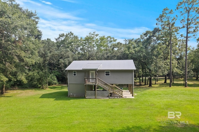view of outdoor structure featuring stairs and view of wooded area