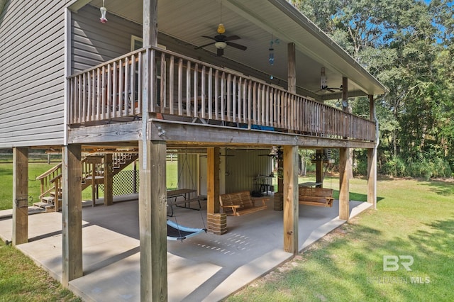view of patio / terrace featuring ceiling fan, a wooden deck, and stairs
