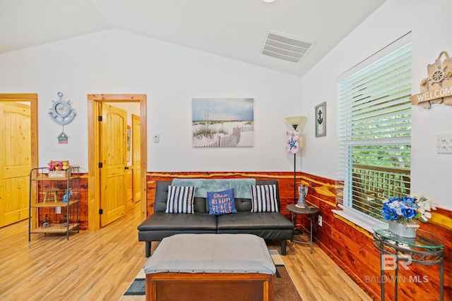 living area with lofted ceiling and wood finished floors