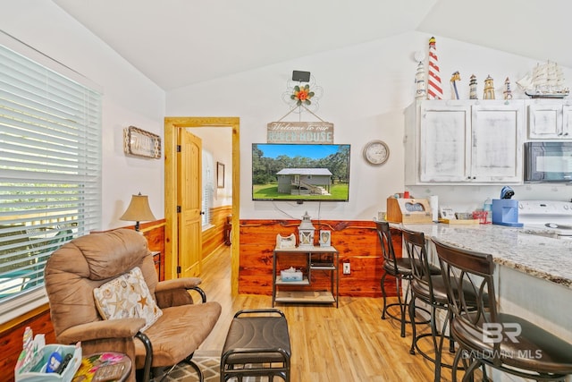 interior space featuring light hardwood / wood-style flooring and vaulted ceiling