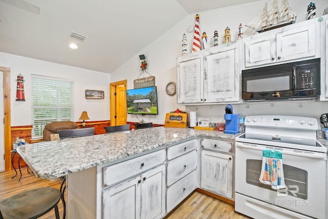 kitchen featuring white range with electric stovetop, black microwave, a peninsula, vaulted ceiling, and light wood-style flooring
