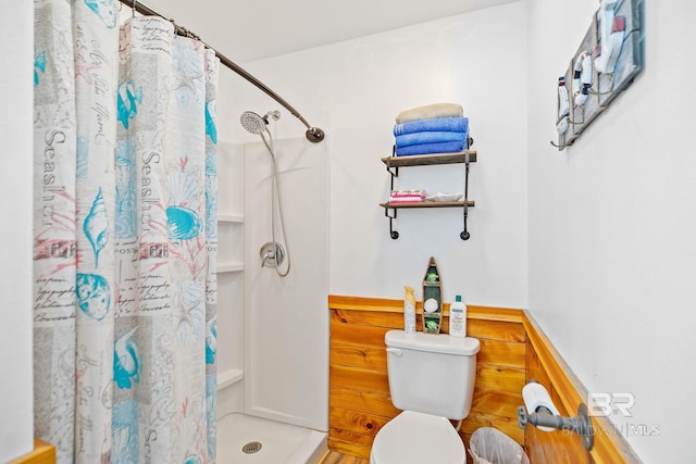 bathroom with curtained shower and toilet