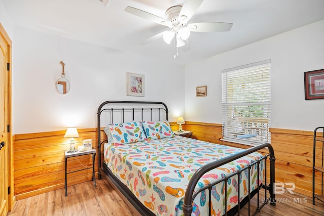 bedroom with ceiling fan and light hardwood / wood-style floors