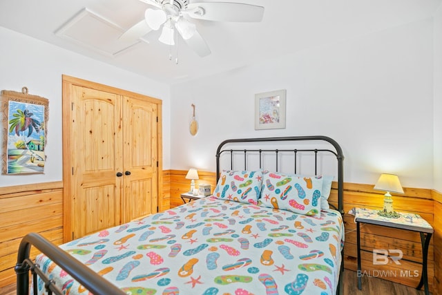 bedroom featuring ceiling fan, a closet, and hardwood / wood-style floors