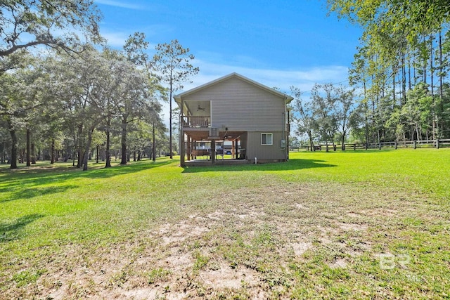 rear view of house with a wooden deck and a yard