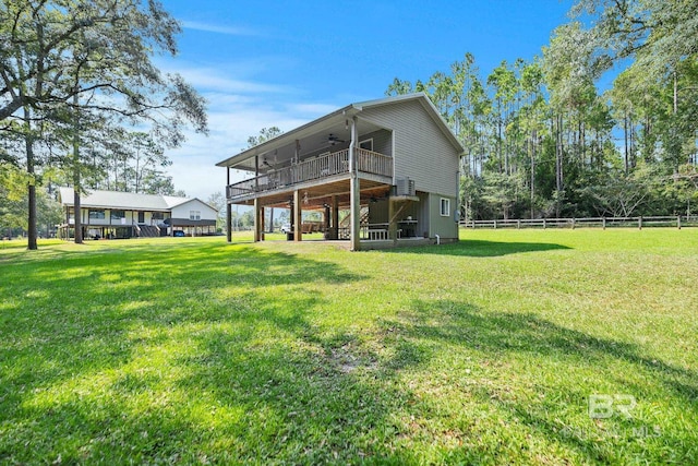 back of property with ceiling fan and a wooden deck