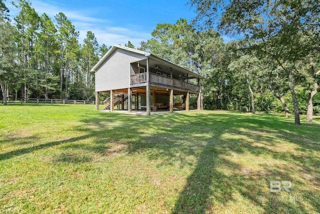 rear view of property featuring ceiling fan, stairs, a wooden deck, and a patio area