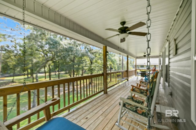 wooden deck featuring ceiling fan