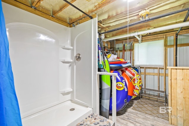 bathroom with hardwood / wood-style floors and walk in shower