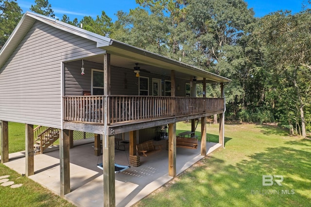 back of property with ceiling fan, a patio, a deck, and a yard