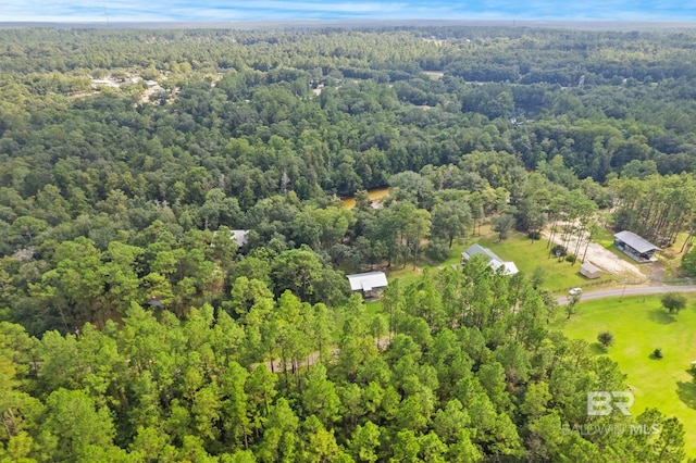 aerial overview of property's location with a heavily wooded area