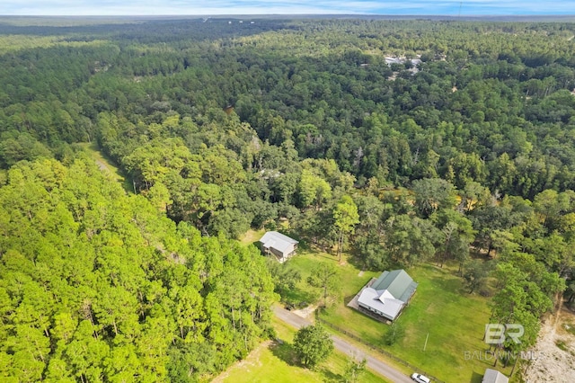 view of property location with a heavily wooded area