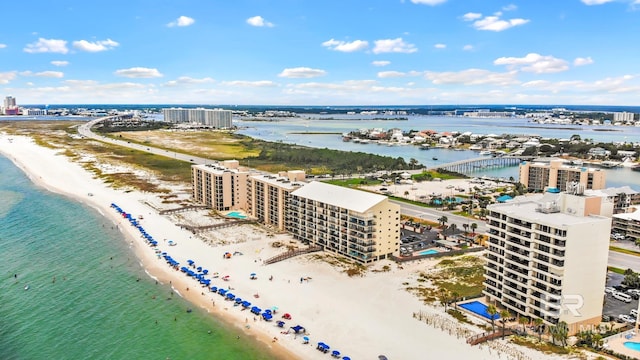 bird's eye view featuring a water view and a beach view