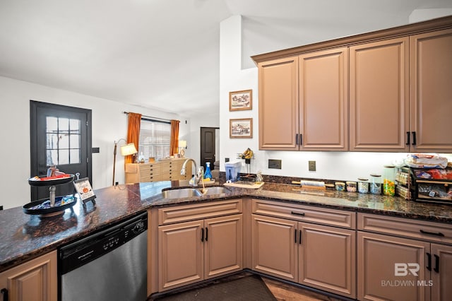 kitchen featuring dishwasher, kitchen peninsula, sink, and dark stone counters