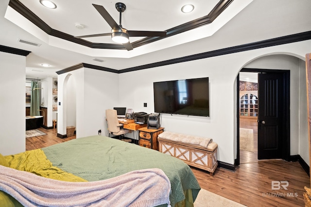 bedroom with ensuite bathroom, ornamental molding, and light wood-type flooring